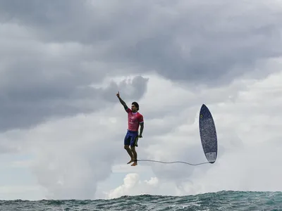 Brazilian Olympic surfer Gabriel Medina pops up after riding a barrel wave at Teahupo'o during the Summer Games on Monday. The photo by Jérôme Brouillet has gone viral.