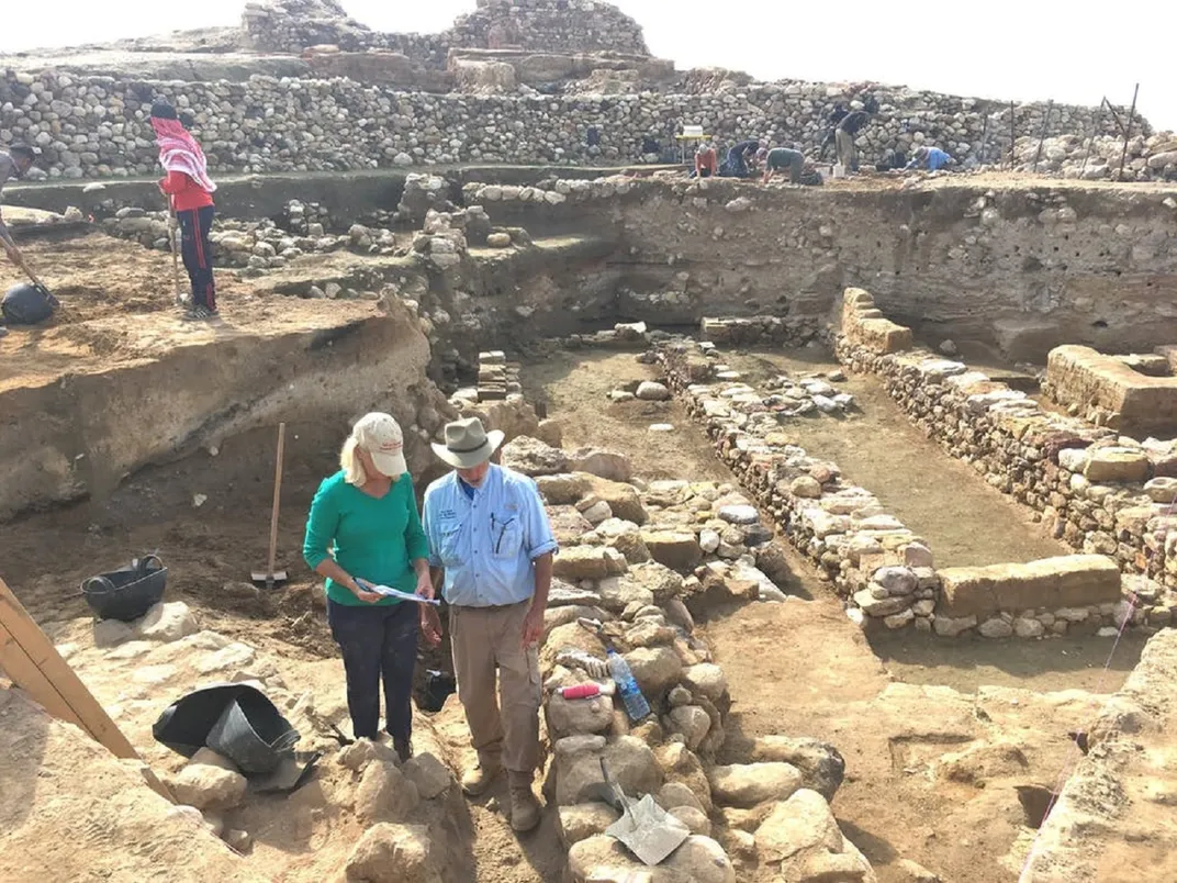 Researchers stand in the city's ruins