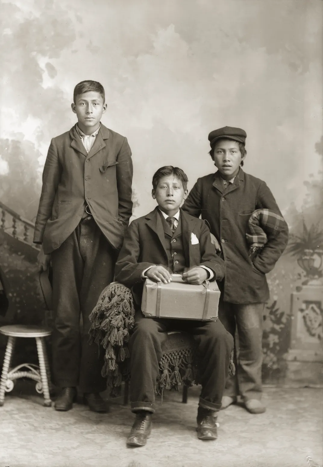 three Native American boys posing for a studio portrait in Black River Falls, Wisconsin, in 1910