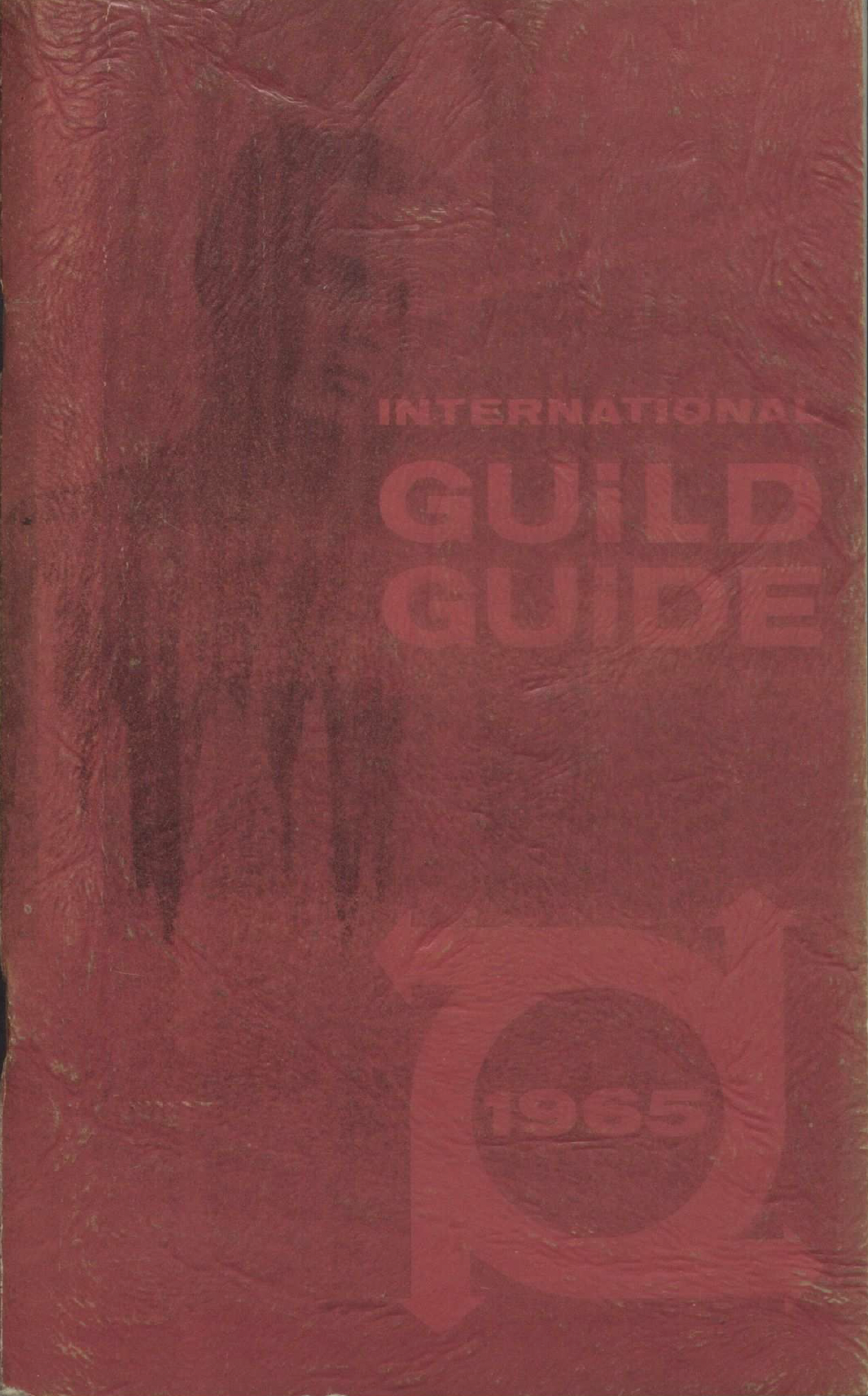 A man’s torso was faintly visible on the cover of the International Guild Guide.