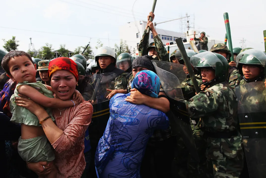 Police and protesters in Urumqi during the July 2009 ethnic riots