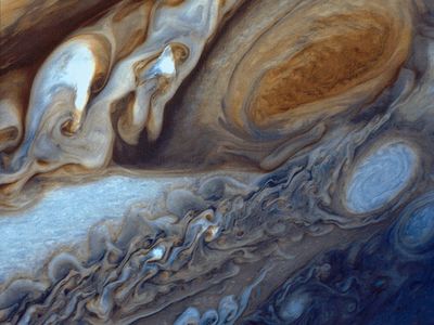 A false-color image of the Great Red Spot of Jupiter from Voyager 1. The white oval storm directly below the Great Red Spot has approximately the same diameter as the Earth.