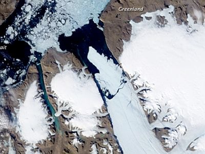 An island of ice breaking away from Greenland’s Petermann Glacier (in the center of the photo) in the summer of 2010.