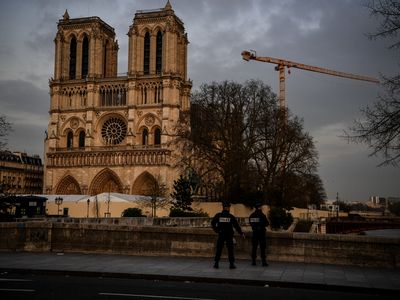 Policemen patrol the streets near Notre-Dame on March 17, 2020, as a strict lockdown comes into effect.