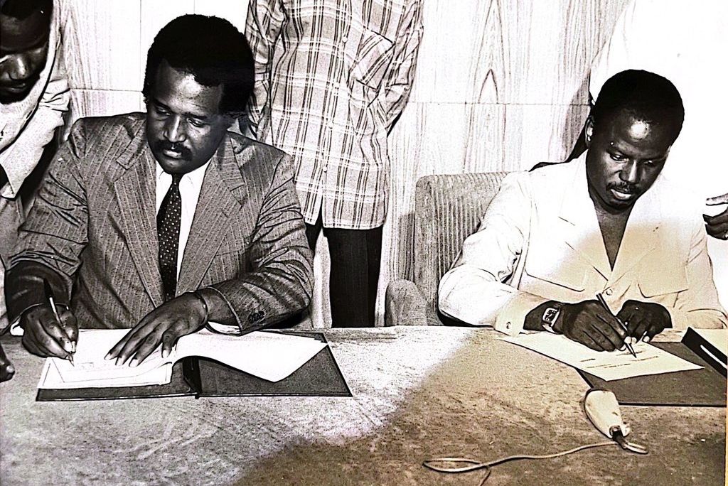 John H. Smith signs a document