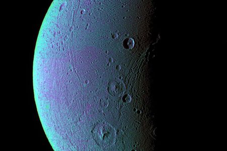 The leading hemisphere of Dione shows tectonic faults running across its surface, along with craters, in false color, which was produced by an image in the ultraviolet, green, and infrared wavelengths taken by the Cassini Orbiter. The subtle variations in color may be caused by fine ice particles. 