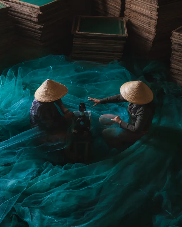 "Mending the Waves" - Vietnamese Workers Repairing a Fishing Net thumbnail