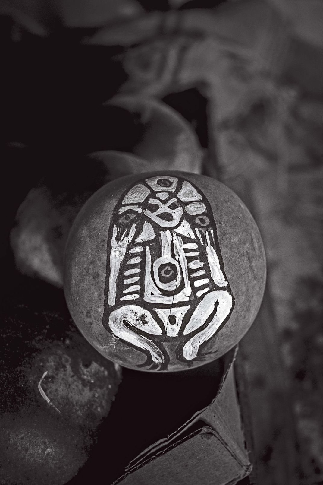 a black and white photograph of a handmade percussion instrument
