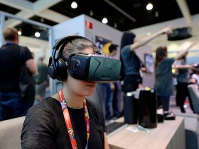 An attendee at the 2014 Electronic Entertainment Expo,  in Los Angeles, California, tries out an Oculus VR headset kit.