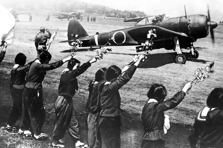 Chiran high school girls wave cherry blossom branches to a kamikaze pilot departing in a "Hayabusa" fighter, April 12,1945.