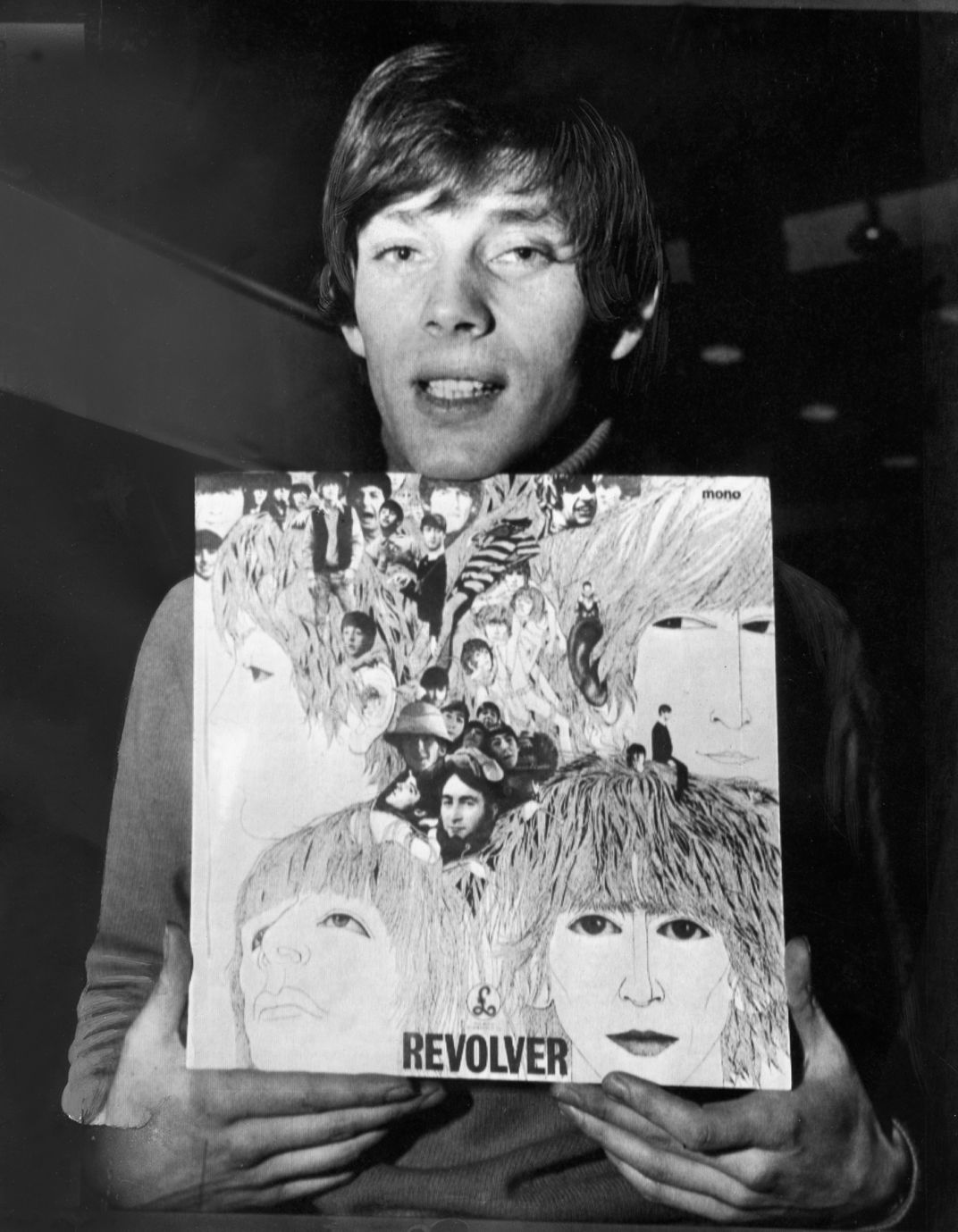Klaus Voormann holding his artwork for Revolver