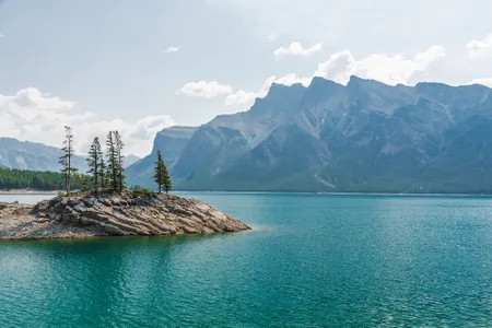 Beneath the surface of Lake Minnewanka, located in Alberta, Canada, rests the remains of a former resort town. 