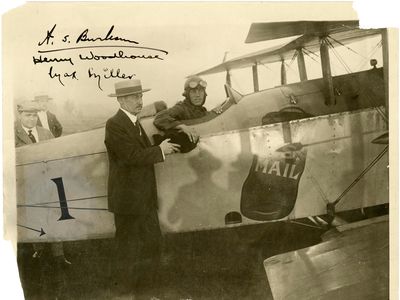 For the first New York-to-Chicago mail flight, in 1918, Max Miller accepts a mailbag from New York City Postmaster Thomas Patten.
