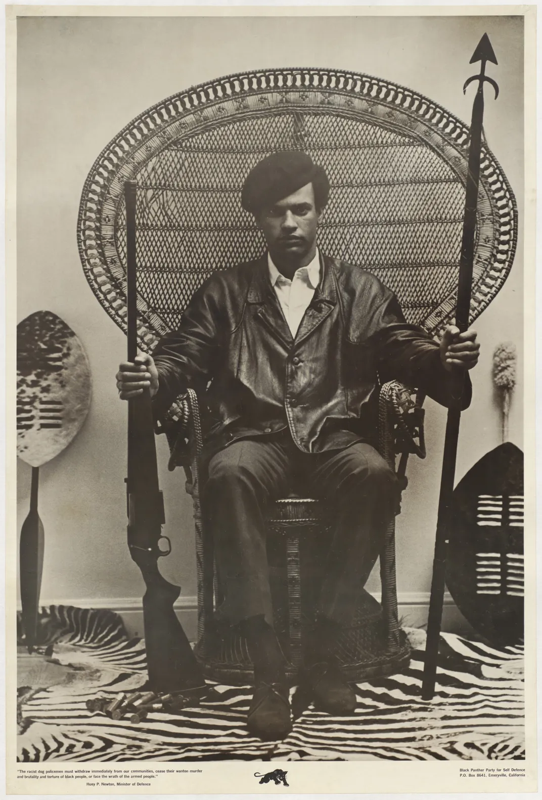 Eldridge Cleaver circulated this 1967 photograph of Huey posing with a spear and a rifle.