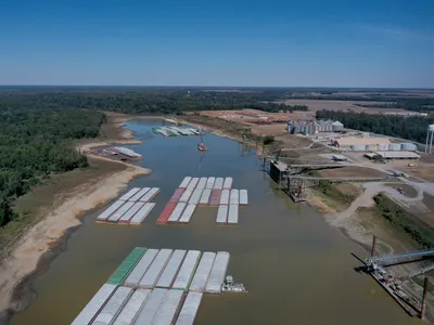 Barges stranded by low water in the Mississippi River in Rosedale, Mississippi, a small town near where the lion fossil was found