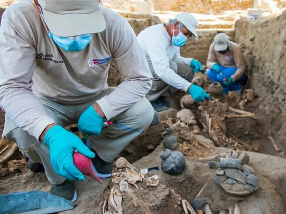 Workers excavate grave site