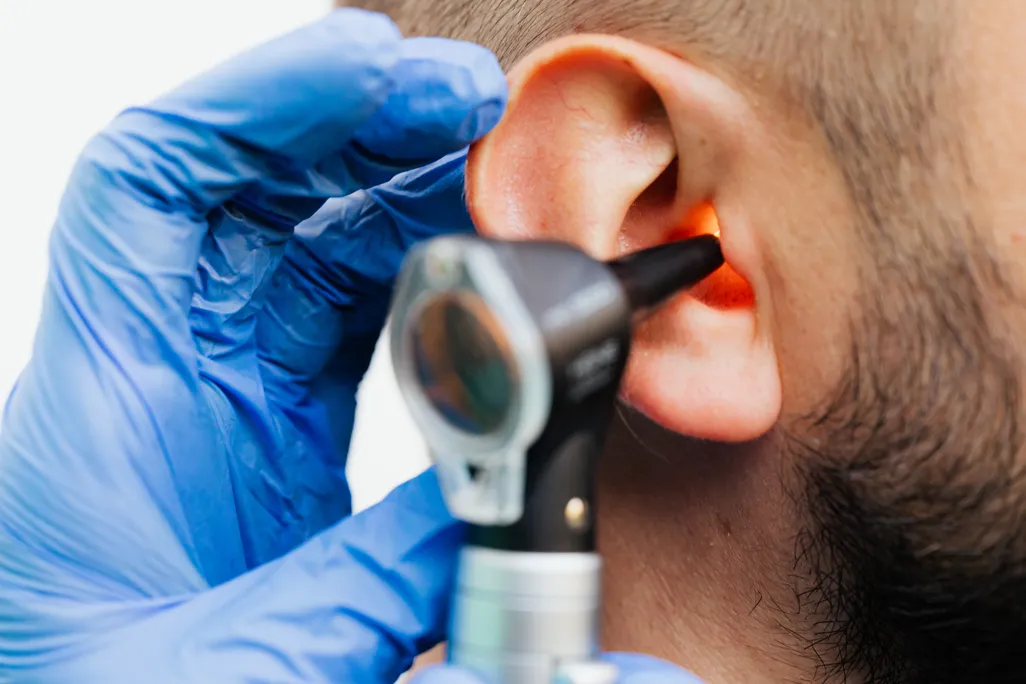 Doctor looking into someone's ear