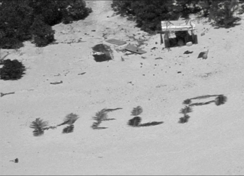 HELP spelled out on beach