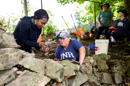 Researchers Kabria Baumgartner and Meghan Howey at the dig site