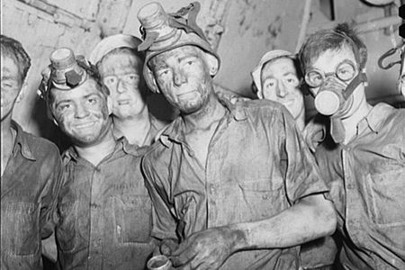 Merchant Mariners aboard a training ship working in the boiler room.