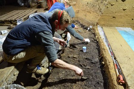 Scientists excavate bones at Bacho Kiro Cave in Bulgaria. Four modern human bones were recovered from this layer along with a rich stone tool assemblage, animal bones, bone tools and pendants.