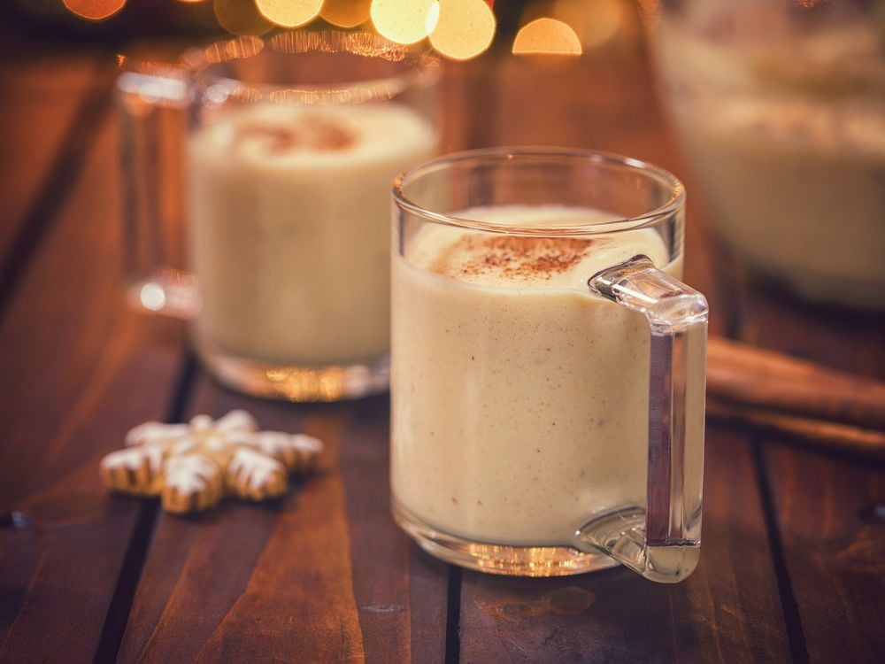 two glasses full of eggnog sit on a table