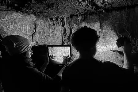 Researchers documenting and analyzing the inscriptions