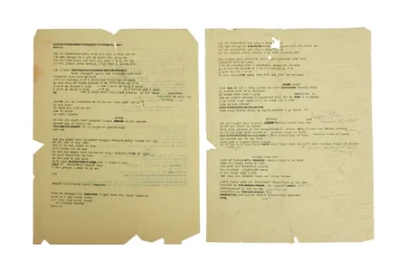 The two sheets of yellowed paper contain three typewritten drafts of the iconic song.