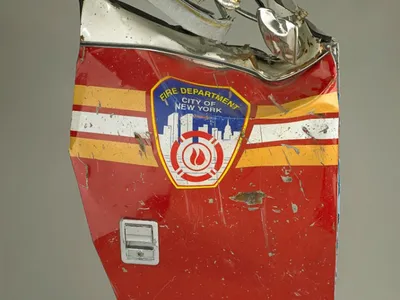 When the first hijacked plane crashed into the World Trade Center, the New York Fire Department immediately responded. Officers set up a command center in the lobby of the north tower and bravely rushed up the stairs to rescue the trapped occupants and put out the raging fires. When the towers collapsed, numerous trucks were crushed, and 343 members of the New York Fire Department were killed. 

This door is from a FDNY rescue pumper truck destroyed in the World Trade Center collapse. The truck belonged to Squad One of Brooklyn, part of FDNY’s Special Operations Command, an elite group of firefighters who respond to unique fire and emergency situations. Squad One lost 12 members on September 11.

Caption from the National Museum of American History's Bearing Witness to History.
