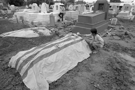 A girl in Vietnam puts flowers on her father’s grave in 1972
