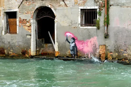 Migrant Child depicts a shipwrecked young child in a life jacket holding up a flare emitting bright pink smoke.