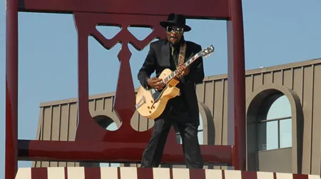 Go-go legend Chuck Brown poses on the Big Chair, a downtown Anacostia landmark.