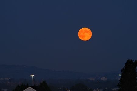 A full moon on June 28, 2018, as seen from Manchester, England. The reddish glow is likely due to the 2018 Saddleworth Moor wildfires.&nbsp;