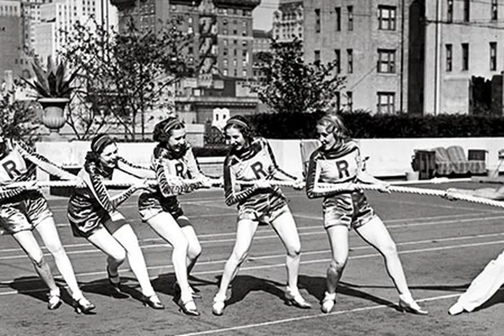Charles Atlas tug of war with Rockettes