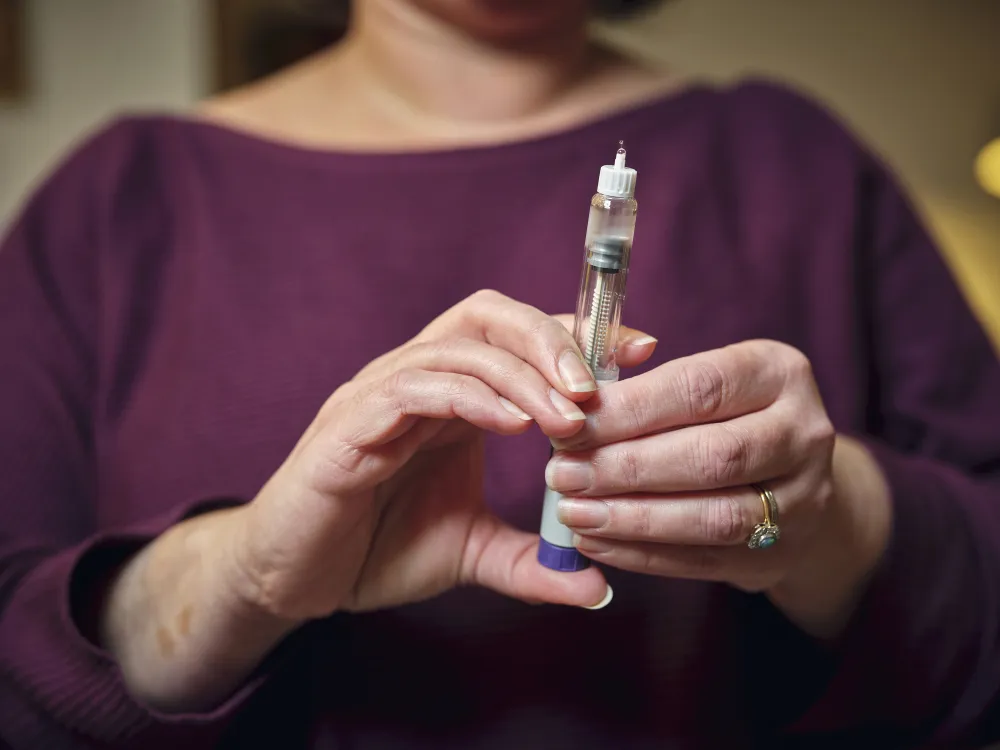 a woman holds an injectable tube