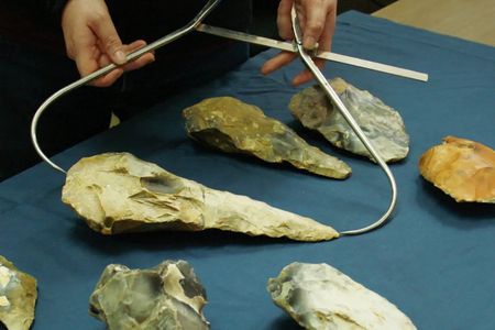 Archaeologist Letty Ingrey measures one of the hand axes.
