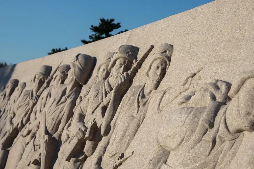A relief sculpture war depicting soldiers