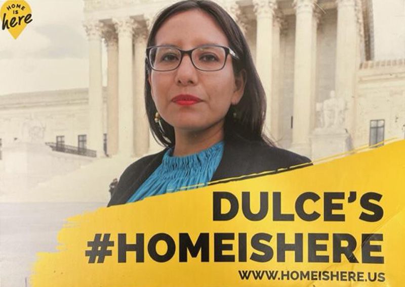 Placard with a photo of Dulce Garcia in front of the U.S. Supreme Court building, with the text "Dulce's #HomeIsHere."