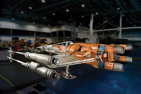 The blackened “laser-scarring” on the hull of this full-scale Star Wars prop is an example of the kind of camera-friendly damage conservators take pains to preserve.