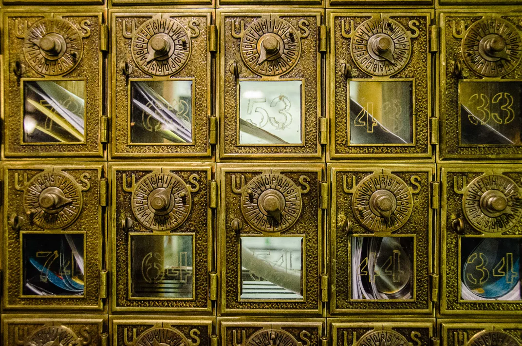 a row of combination lock mail boxes