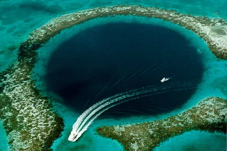 The Great Blue Hole, a 354-foot deep cavern and popular dive site in Belize's Lighthouse Reef