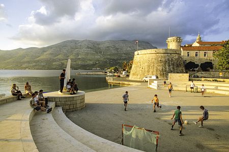 Youngsters play soccer near a fort at the port of Korčula, which once served as the arsenal of the Venetian Empire in the Adriatic.