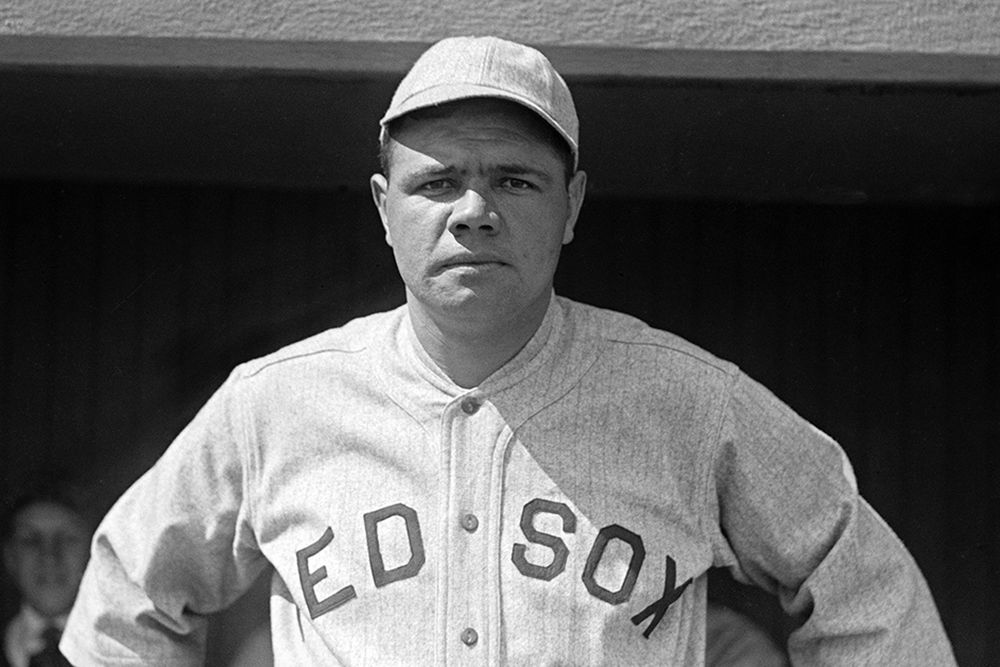 Babe Ruth, wearing a Red Sox uniform, looks squarely at the camera