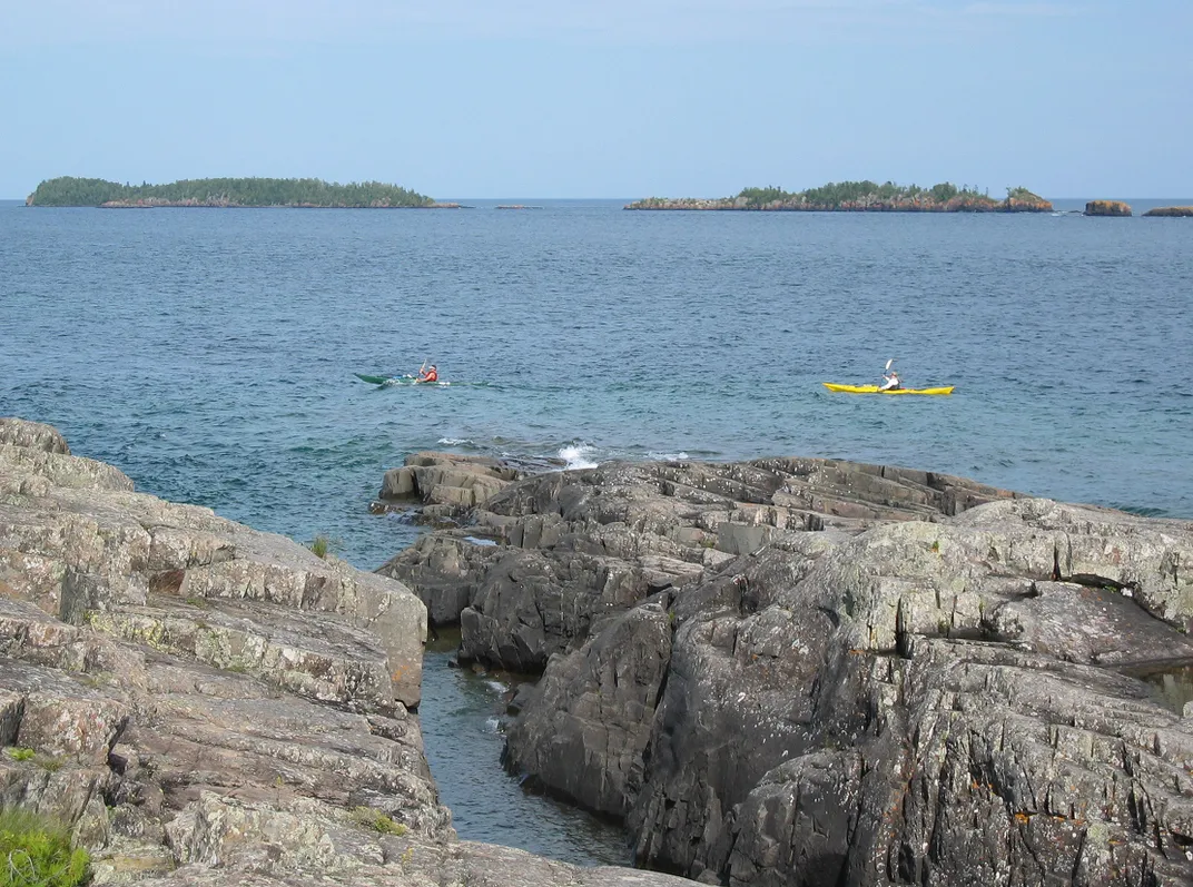 Kayakers paddling on water