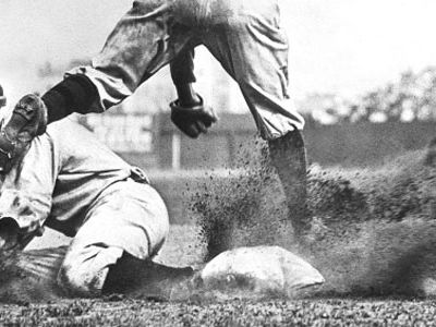 Charles M. Conlon was a proofreader at the New York Telegram when he began shooting pictures as a hobby. Shown here is one of his iconic photographs of Ty Cobb sliding into third base.