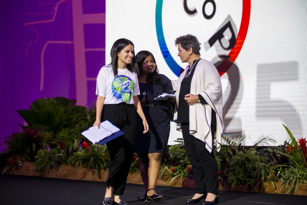 three women meet on stage