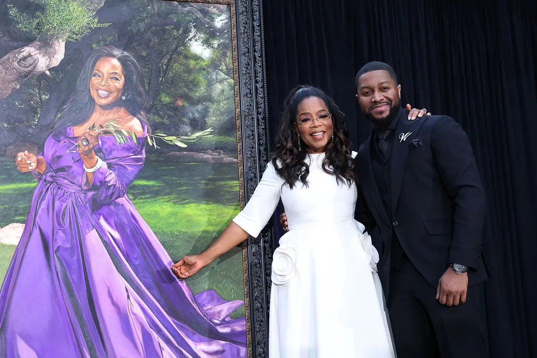 Oprah Winfrey and artist Shawn Michael Warren pose alongside the newly unveiled portrait.