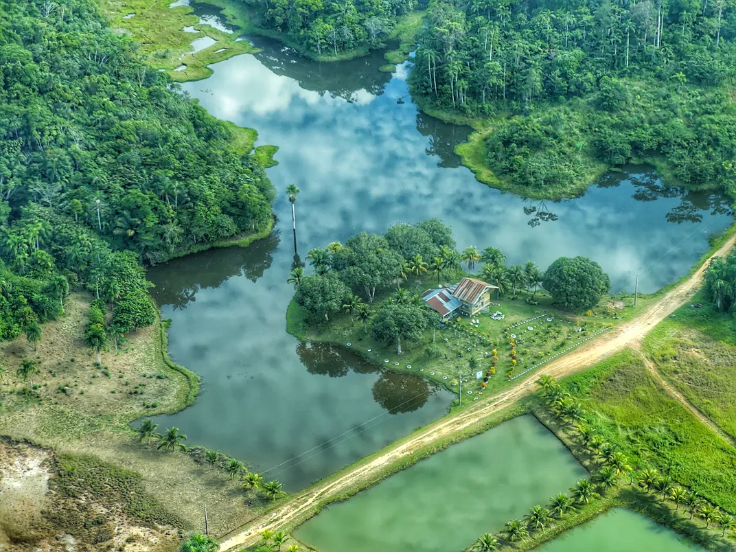 A small house offers peak solitude, isolated on a grassy peninsula in the Amazon.