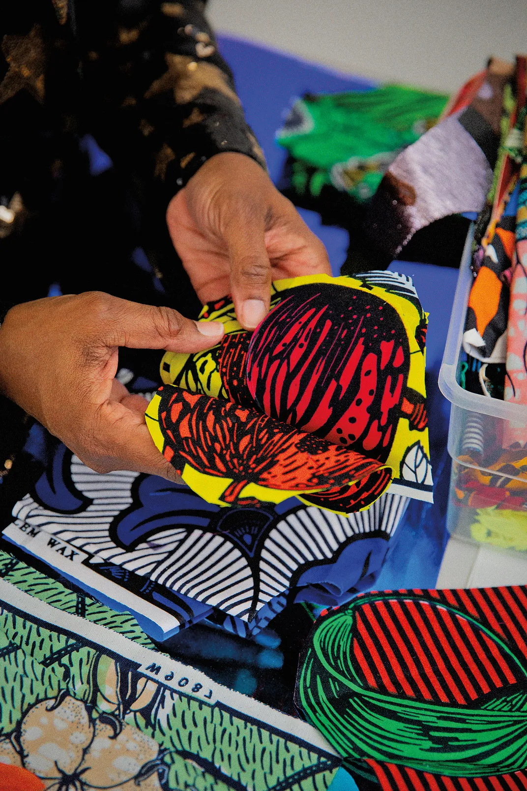 a close up detail of patterns made from fabric being held in a persons hands