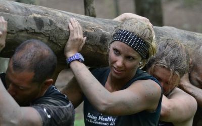 Participants in a MovNat course carry logs and perform other backwoods workout drills with the goal of retraining their bodies to a level of fitness that our species forgot long ago.